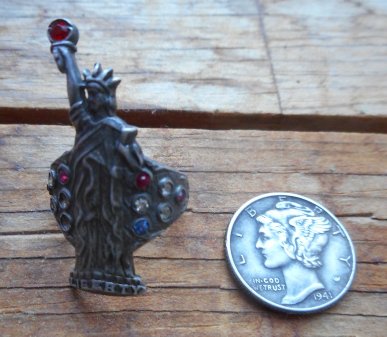 A very cool and unique Statue of Liberty silver ring, found in Whitman, along with a 1941 Mercury dime.
