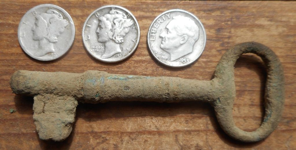 Obverse of silver dimes and skeleton key